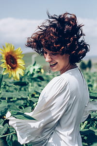 Woman Smiling at Field of Sunflowers thumbnail