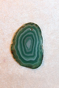 teal and black geode on white surface thumbnail