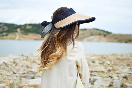 woman standing next to body of water thumbnail