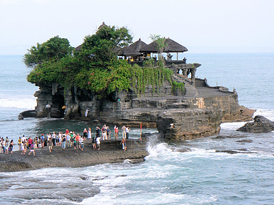 group of people on rock beside body of water thumbnail