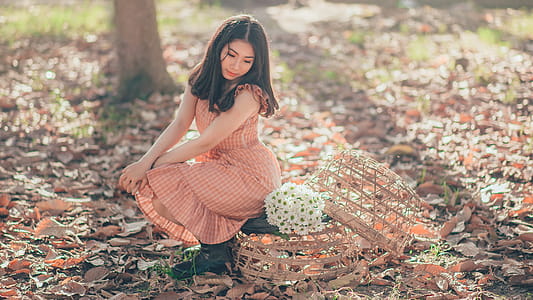 Woman Sitting Beside a Flower Bouquet thumbnail