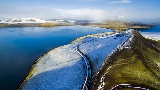 blue sea near mountain under white clouds and blue sky painting thumbnail