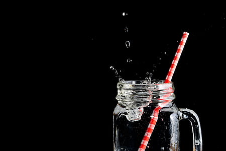 clear mason jar drinking glass with splatted water thumbnail