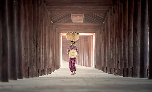 woman carrying wicker basket while walking thumbnail