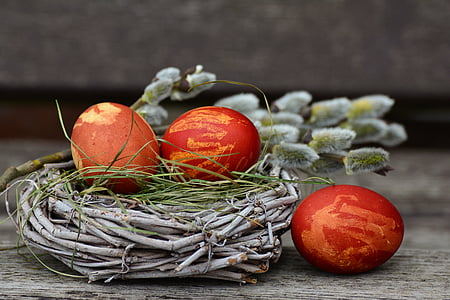 three red and brown eggs on nest thumbnail