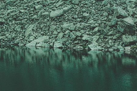 Rocks Near Calm Body Of Water thumbnail