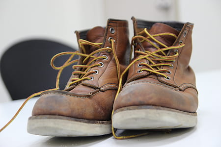 pair of brown leather lace-up shoes on white panel board in selective focus photography thumbnail