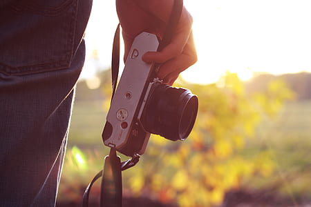 person holding gray and black camera thumbnail