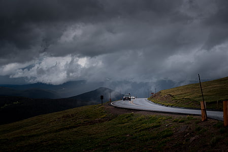 vehicles on road under gloomy skies thumbnail