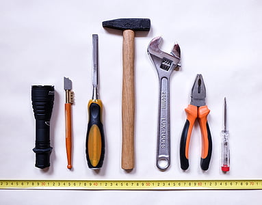 seven assorted-color handheld tools on white background thumbnail