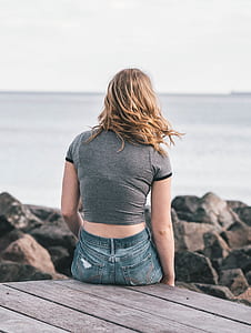 woman sitting on brown boardwalk thumbnail