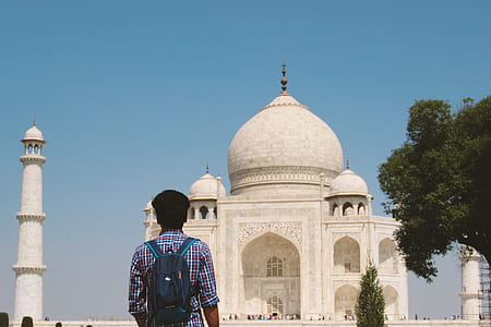 man standing in front of Taj Mahal mosque thumbnail