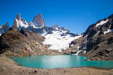 lake beside mountains at daytime thumbnail