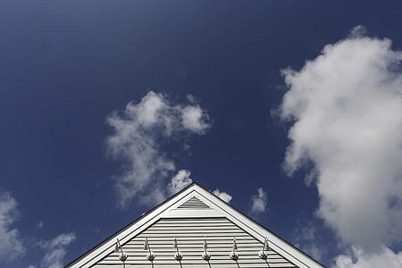 low-angle photography of house under cloudy sky during daytime thumbnail