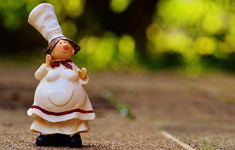 selective focus photography of female chef figurine on surface thumbnail