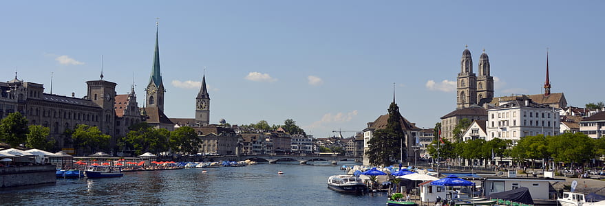 Buildings Near Lake With Boats during Daytime thumbnail