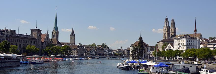 assorted-color boat docks near city under clear blue sky thumbnail
