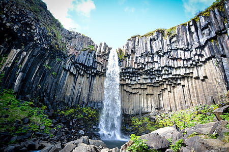 low angle photography of waterfalls at daytime thumbnail