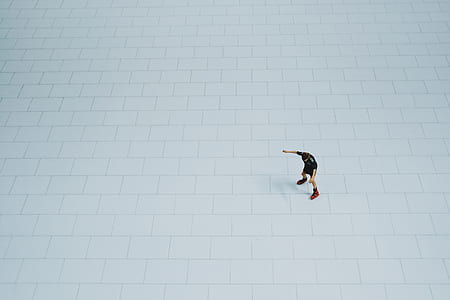 man standing on white tiled floor thumbnail