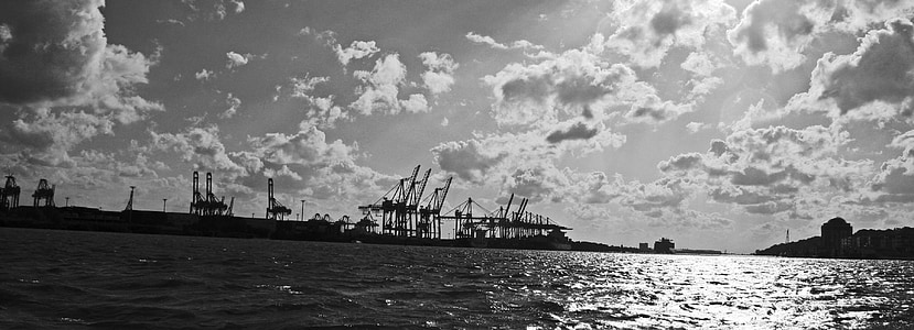 grayscale photography of ocean under clouded sky thumbnail