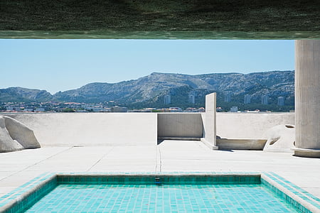 marble building with pool overlooking mountains thumbnail