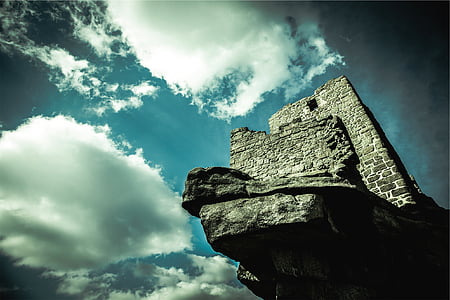 gray brick tower under cloudy sky thumbnail