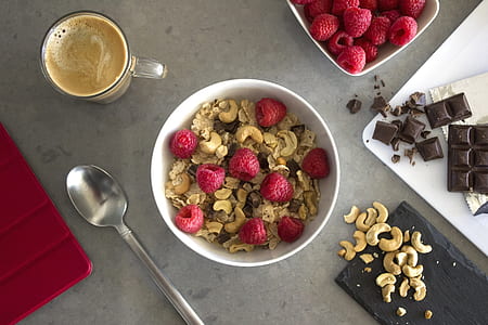 cereals with raspberries on white bowl thumbnail
