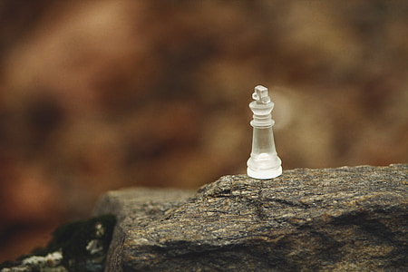 clear glass chess piece in selective focus photography thumbnail