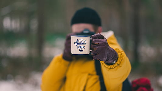 person holding white mug thumbnail