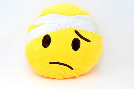 emoji plush toy on white surface thumbnail