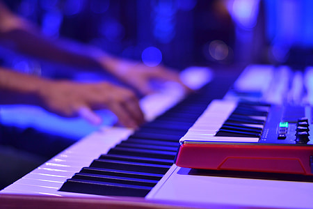 Person playing the keyboard at a music event thumbnail