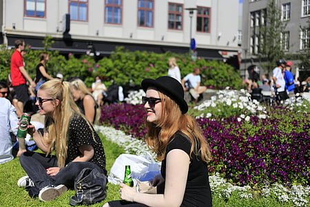 people sitting on grass near building thumbnail