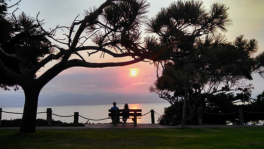 silhouette of two people in front of sunset thumbnail