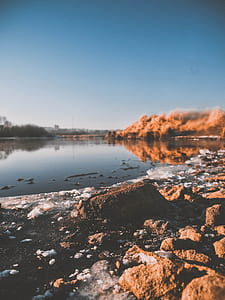 calm body of water and rocks thumbnail