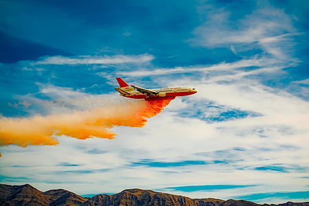 white and red airplane releasing red powder on air thumbnail