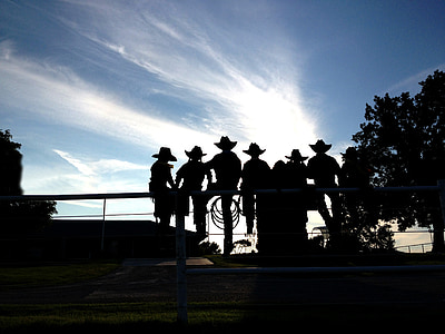 silhouette photo of men sitting the bridge thumbnail