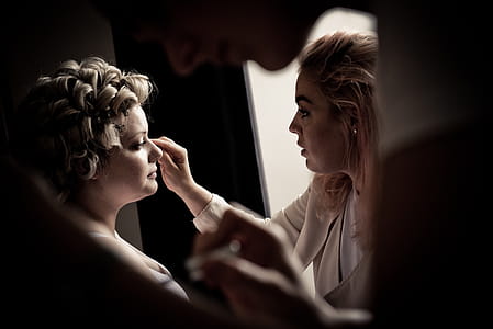Person Putting Makeup On Woman thumbnail