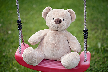 bear plush toy on pink swing thumbnail