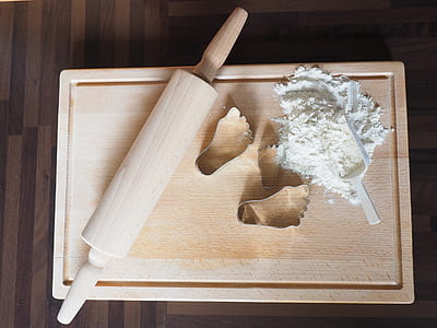 brown wooden rolling pin placed on chopping board thumbnail