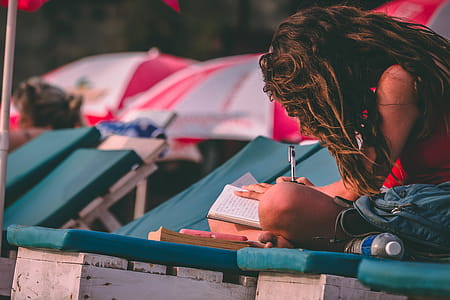 Woman With Red Top Holding Pen and Notebook thumbnail
