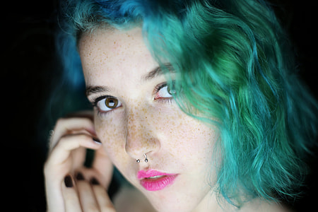 blue and green haired woman in pink lipstick thumbnail