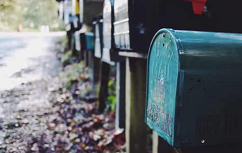 selective focus photo of mail boxes near road thumbnail