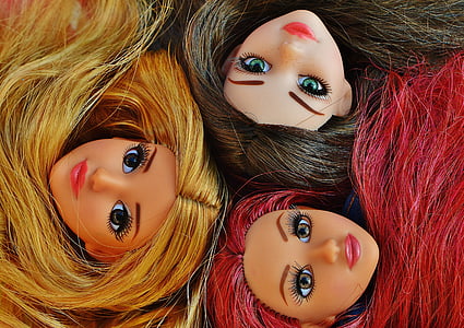 close-up photo of three girl dolls thumbnail