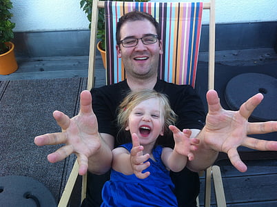 dad and daughter sitting on lounge chair thumbnail