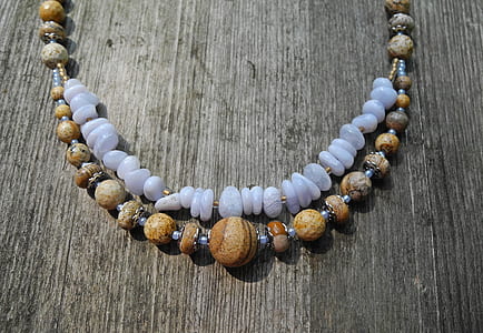 beaded white, black, and brown 2-layer necklace on brown surface thumbnail