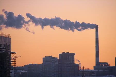 grey smoke coming out from red and white smokestack thumbnail