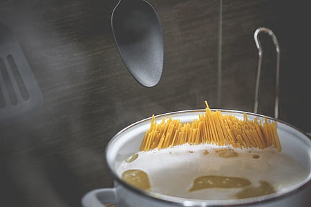 boiling water with pasta on white cooking pot thumbnail