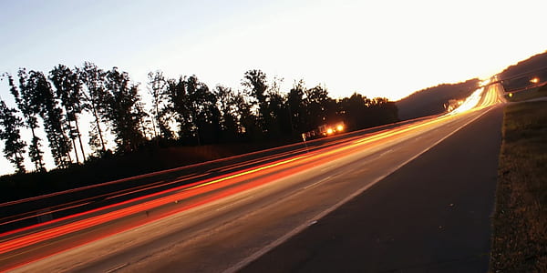 time lapse photography of vehicle on road during daytime thumbnail