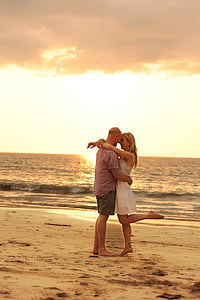 man and woman staring each other near beach thumbnail