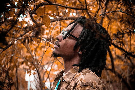 man standing surrounded by trees thumbnail